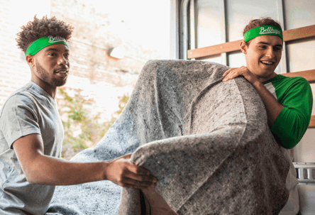 two guys carrying furniture