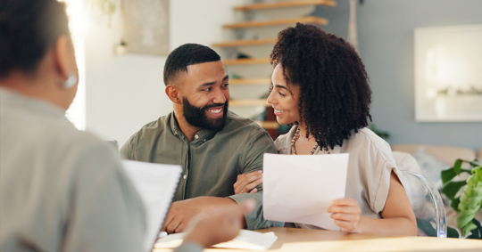 couple reviewing documents with a professional